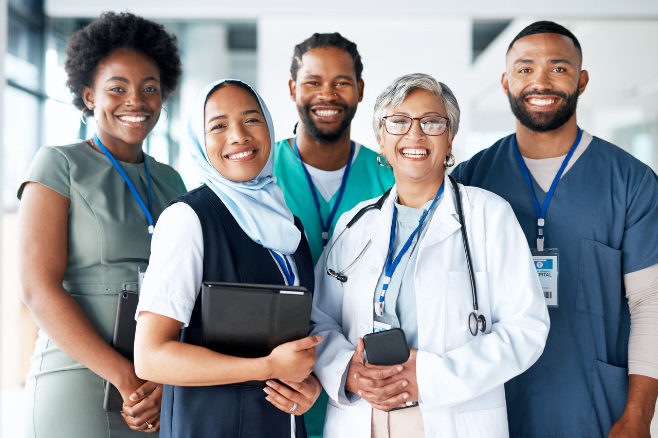 Standing group of 5 medical professionals