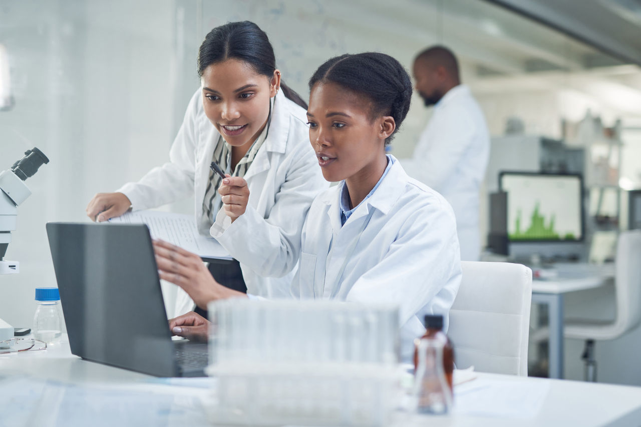 Two medical employees reviewing laptop