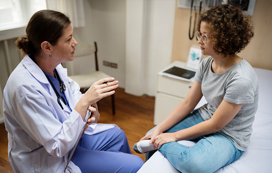 Provider talking to female teen age patient