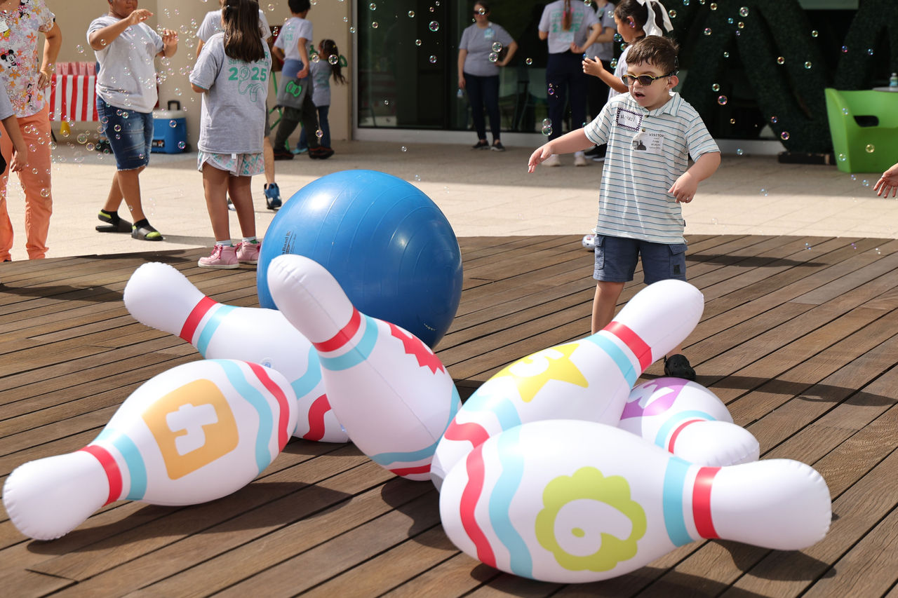 Male child playing at cochlear implant summer camp