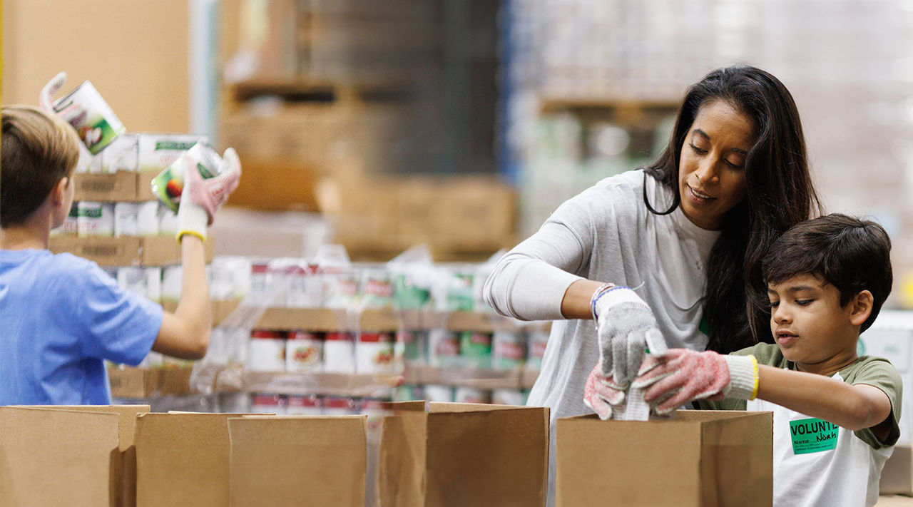 Parent with child filling bags for donationa