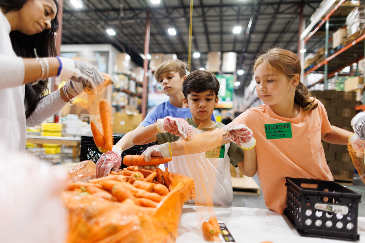 diverse families in need in line waiting for food bank distribution