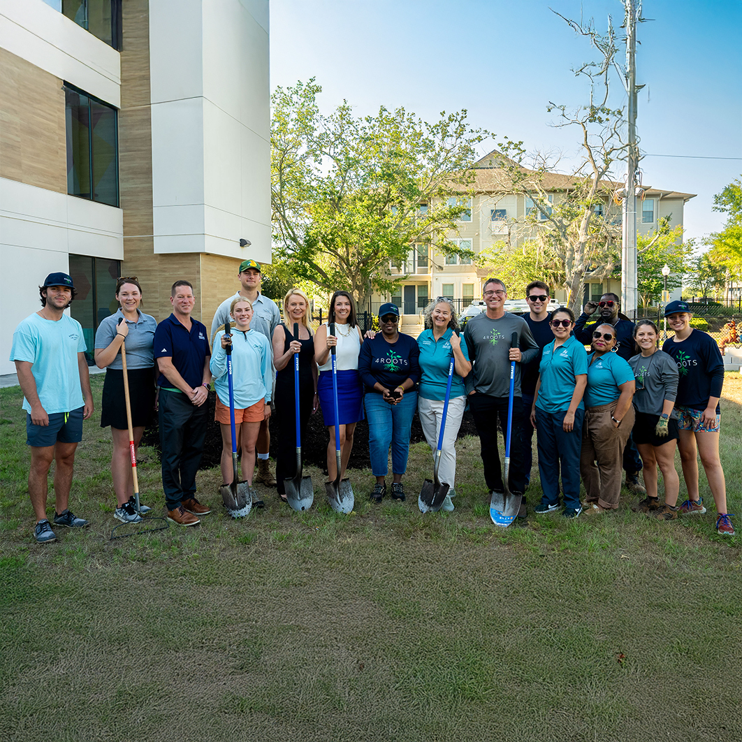 The B&G club garden event with members standing with shovels.